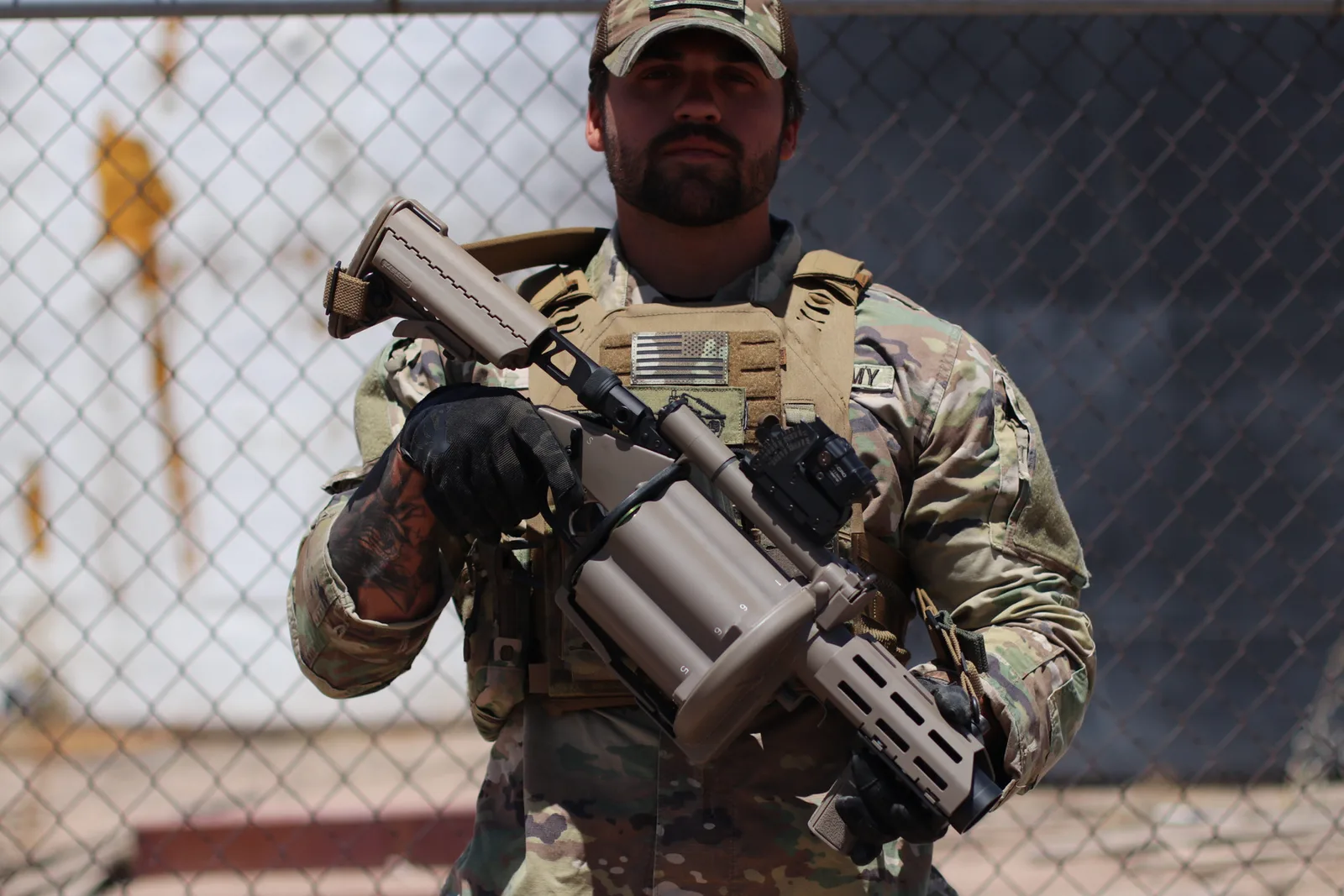 Milkor USA operator cradling the M32A1 Multi-Shot Grenade Launcher