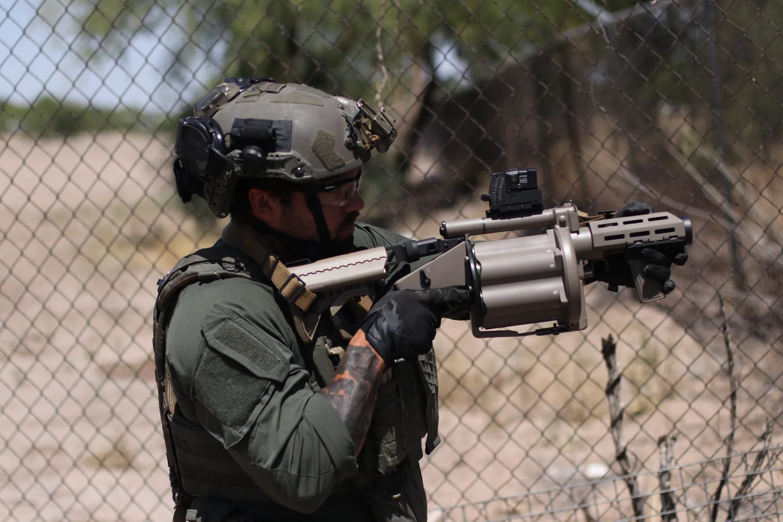 Milkor USA operator shouldering the M32A1 Multi-Shot Grenade Launcher